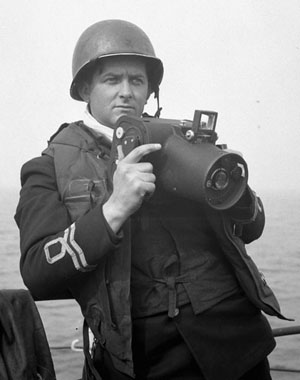 Lieutenant Gilbert Milne of the Royal Canadian Naval Volunteer Reserve, four days before D-Day, with his Fairchild K-20 camera.
