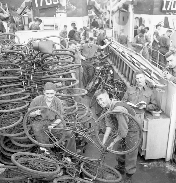 Infantrymen checking bicycles aboard an LCI in Southampton, England.