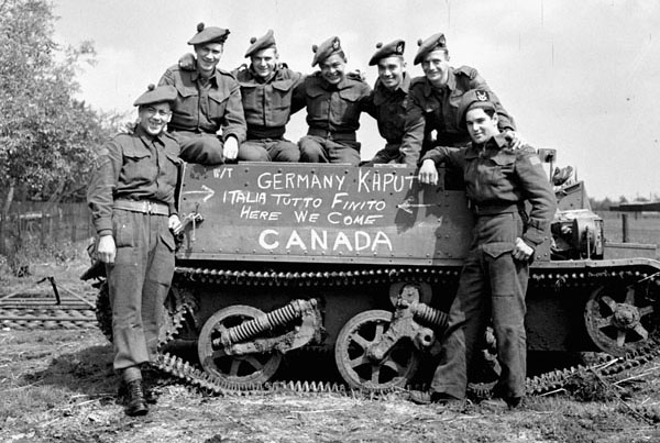 Canadian Soldiers pose at news of surrender